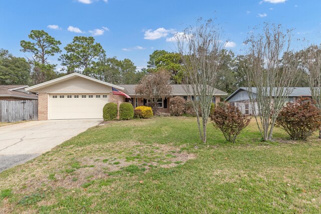 ranch-style house with brick siding, an attached garage, a front yard, fence, and driveway