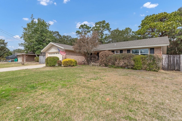 ranch-style home featuring brick siding, a front yard, fence, a garage, and driveway