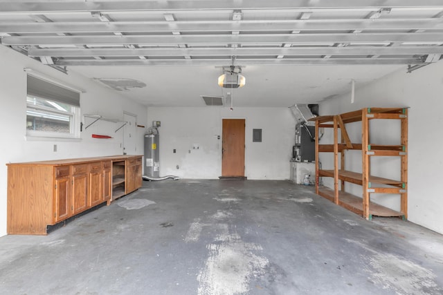 garage featuring a garage door opener, water heater, heating unit, and a workshop area