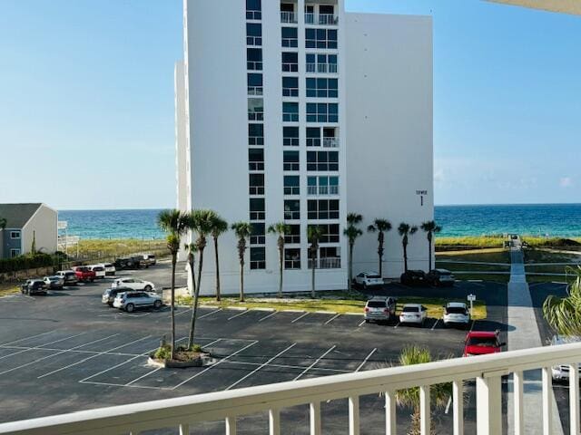 view of property with a water view and uncovered parking