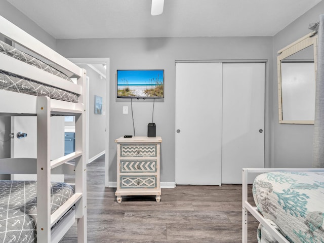 bedroom with a ceiling fan, a closet, and wood finished floors