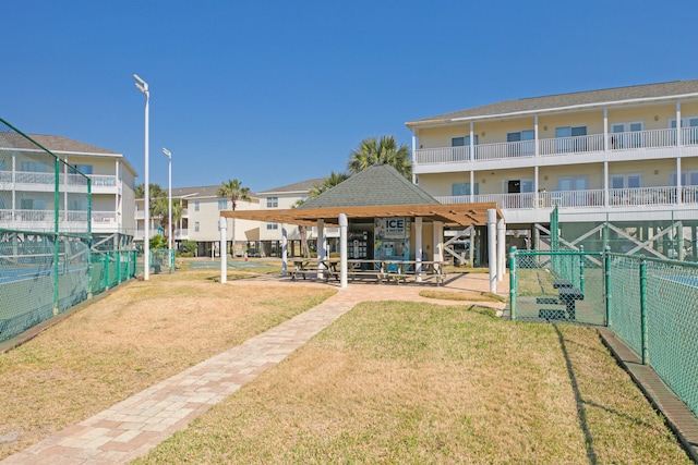 view of property's community with a yard and fence