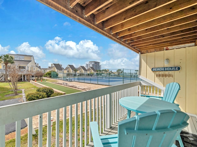 balcony featuring a tennis court