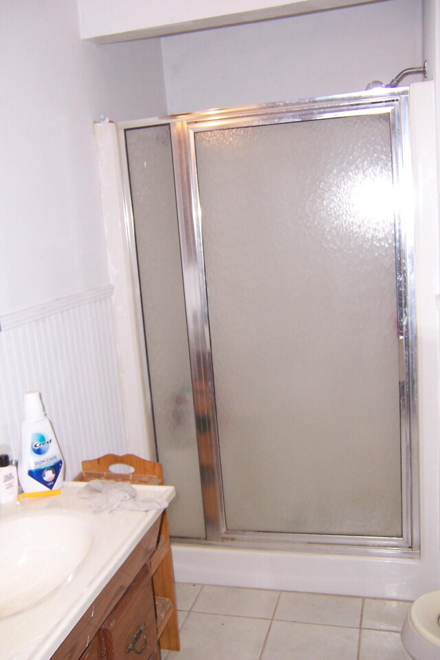 1100 Kings Lake Blvd, Defuniak Springs, FL 32433 - bathroom featuring tile patterned floors, a stall shower, vanity, and a wainscoted wall