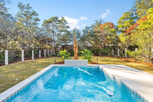 view of swimming pool featuring a yard and a fenced backyard