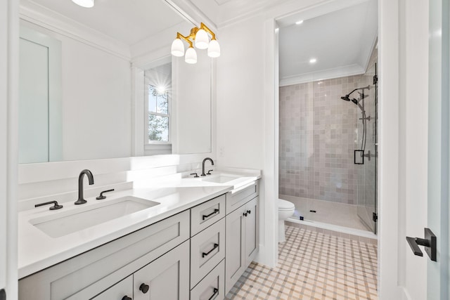 bathroom with double vanity, crown molding, a sink, and a shower stall