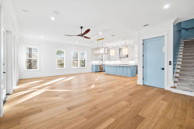 unfurnished living room with recessed lighting, visible vents, stairway, light wood-style floors, and ceiling fan