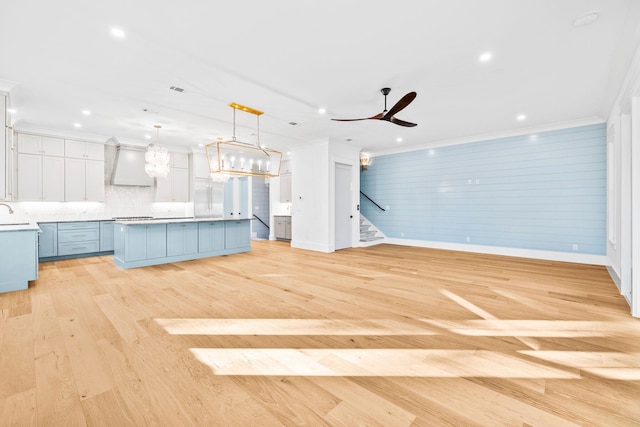 kitchen featuring a center island, pendant lighting, light countertops, and open floor plan