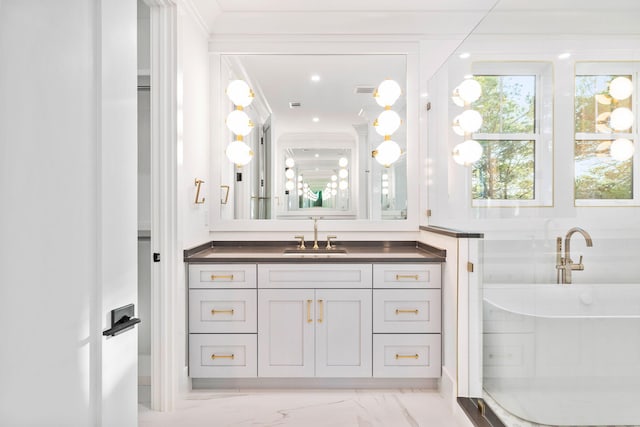 full bathroom with marble finish floor, visible vents, a freestanding bath, and vanity