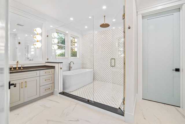 full bath featuring marble finish floor, a shower stall, a freestanding tub, and recessed lighting