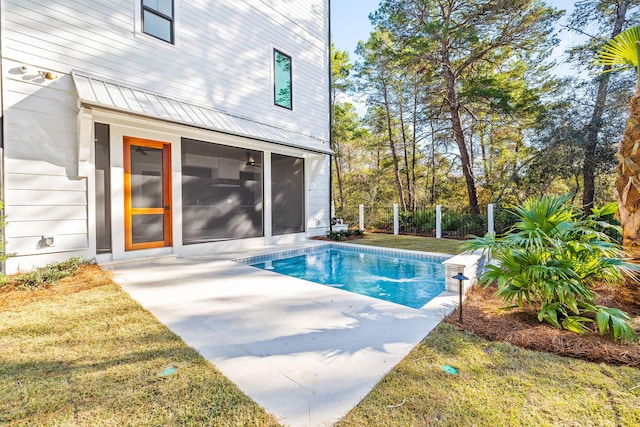 view of pool with a patio area, fence, a lawn, and a fenced in pool