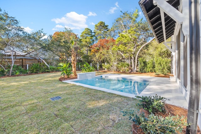 pool with a patio and a lawn