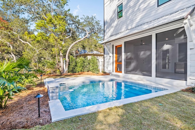 view of pool with a fenced in pool, a sunroom, and a yard