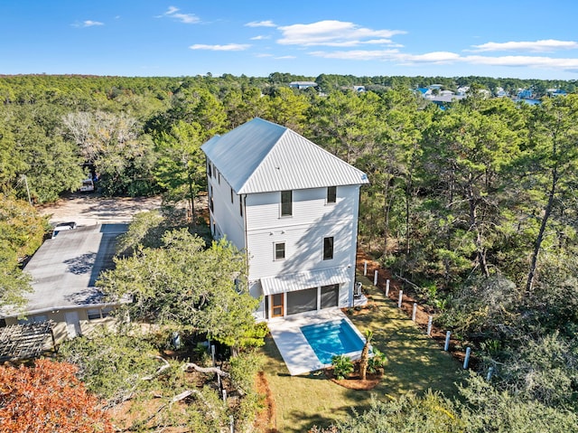 birds eye view of property with a view of trees