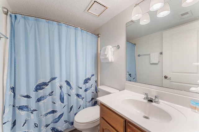 full bathroom featuring visible vents, toilet, a textured ceiling, and vanity