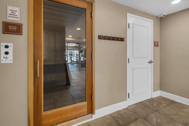 hallway featuring recessed lighting and baseboards