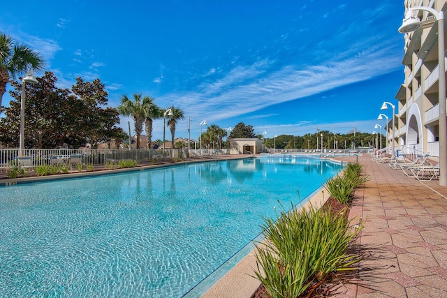 pool with fence and a patio