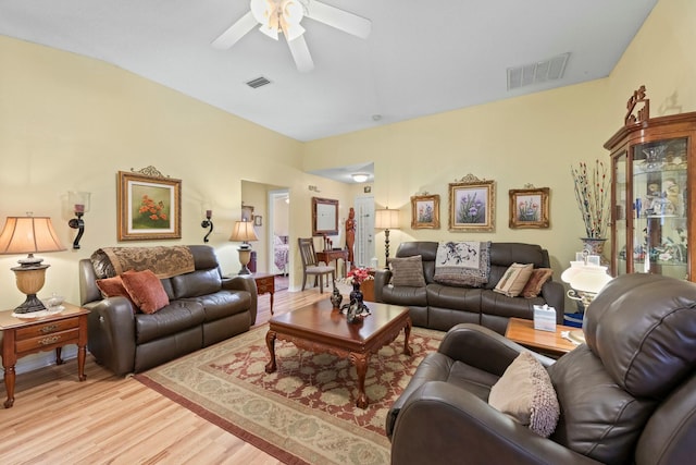 living area with ceiling fan, visible vents, and light wood-style floors