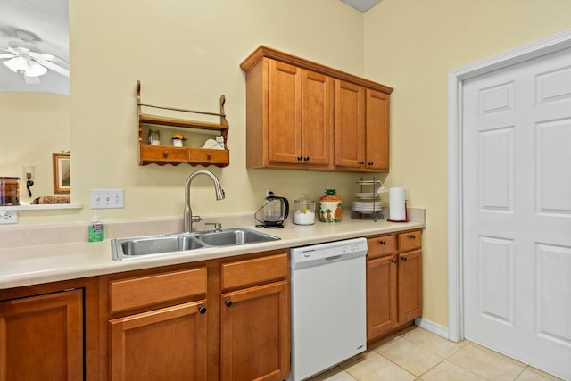 kitchen with light tile patterned floors, brown cabinetry, white dishwasher, light countertops, and a sink