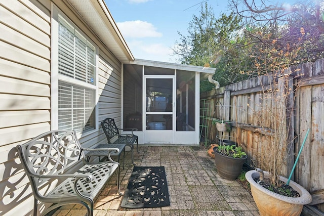 view of patio / terrace with a sunroom and a fenced backyard