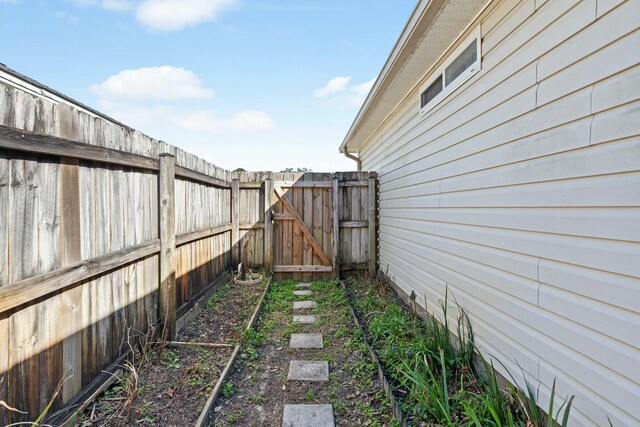 view of yard featuring fence and a gate