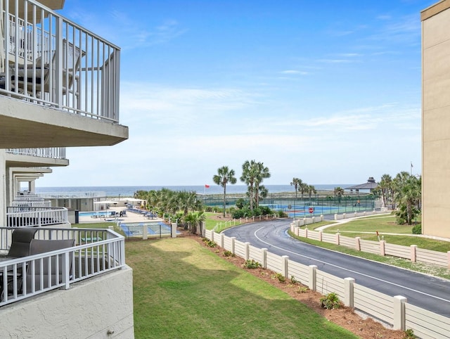 view of yard with a water view and fence