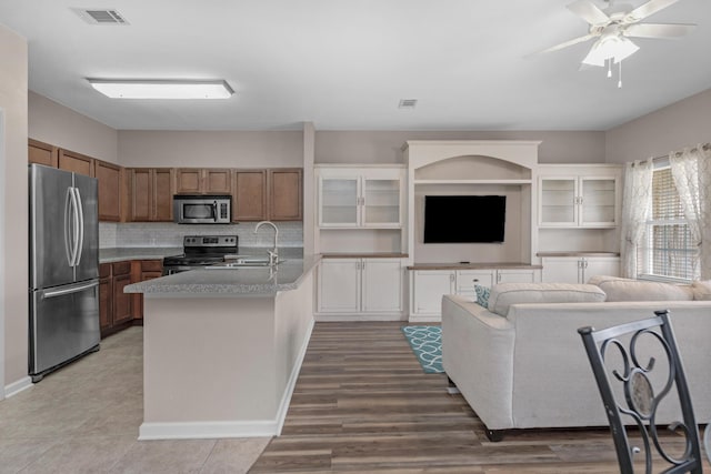 178 E Iron Horse Dr, Crestview, FL 32539 - kitchen with stainless steel appliances, brown cabinets, visible vents, and a sink