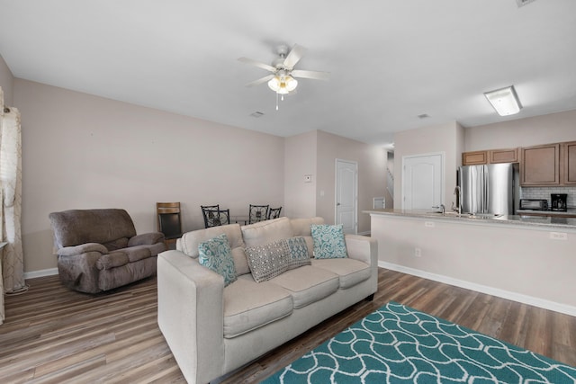 178 E Iron Horse Dr, Crestview, FL 32539 - living area with wood finished floors, a ceiling fan, and baseboards