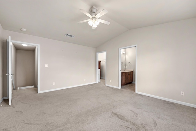 178 E Iron Horse Dr, Crestview, FL 32539 - unfurnished bedroom featuring lofted ceiling, light carpet, visible vents, baseboards, and ensuite bath