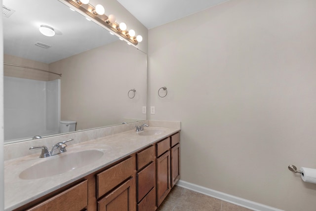 178 E Iron Horse Dr, Crestview, FL 32539 - bathroom featuring tile patterned flooring, a sink, toilet, and baseboards