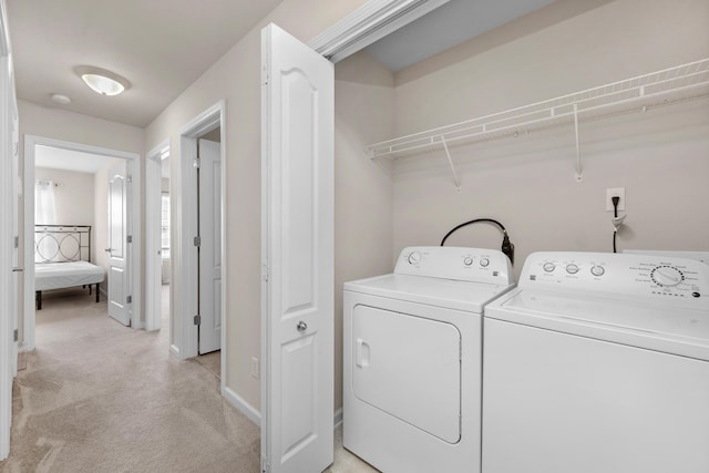 178 E Iron Horse Dr, Crestview, FL 32539 - clothes washing area with light carpet, laundry area, baseboards, and washing machine and clothes dryer