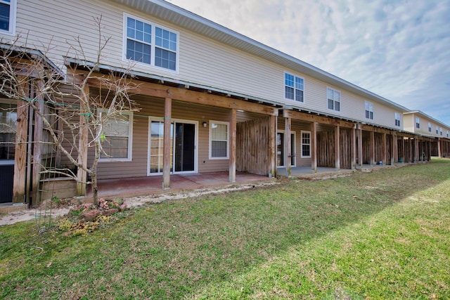 178 E Iron Horse Dr, Crestview, FL 32539 - back of property with a patio area and a lawn