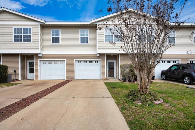 view of property featuring driveway and an attached garage