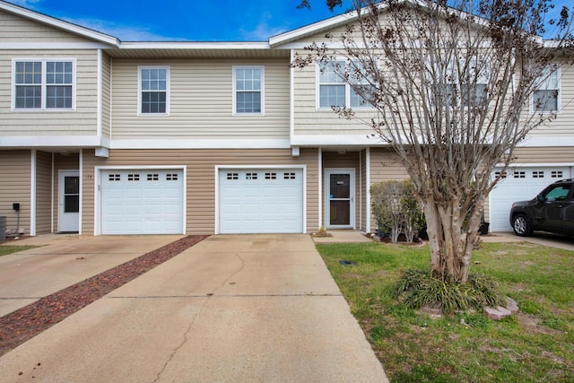 178 E Iron Horse Dr, Crestview, FL 32539 - townhome / multi-family property with driveway, an attached garage, and central AC unit