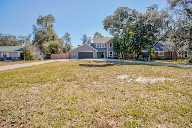 view of front of house featuring a garage, driveway, a front yard, and fence