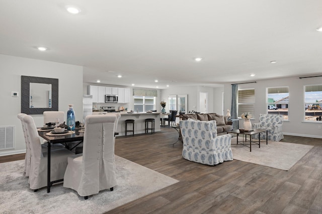 dining space with recessed lighting, visible vents, baseboards, and wood finished floors