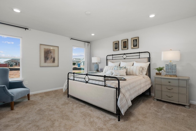 bedroom with recessed lighting, light colored carpet, and baseboards