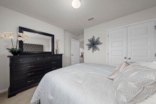 bedroom featuring light carpet, a closet, visible vents, and baseboards