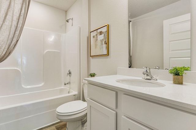 bathroom featuring washtub / shower combination, vanity, toilet, and wood finished floors