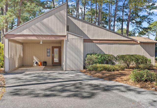 garage with a carport and driveway