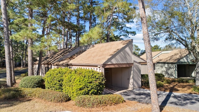 view of side of home with driveway