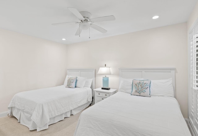 bedroom featuring light carpet, recessed lighting, baseboards, and a ceiling fan