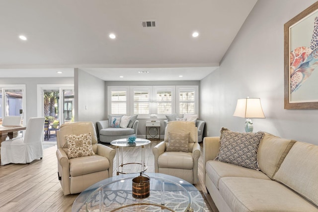 living area with recessed lighting, visible vents, and light wood-style flooring