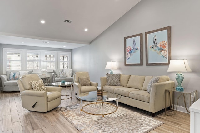 living room featuring light wood-type flooring, visible vents, recessed lighting, baseboards, and vaulted ceiling