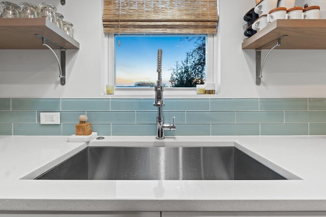 details featuring open shelves, a sink, and light countertops