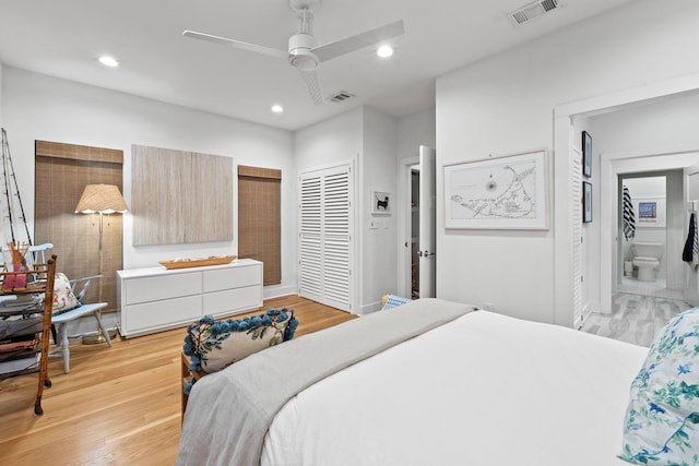 bedroom with ensuite bathroom, light wood-style flooring, visible vents, and recessed lighting