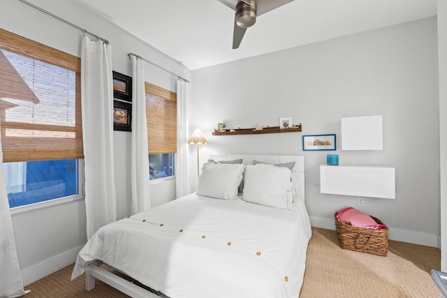 bedroom with a ceiling fan, carpet, and baseboards