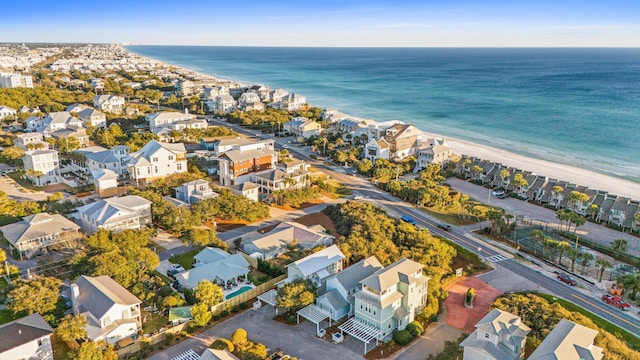 birds eye view of property featuring a water view, a view of the beach, and a residential view