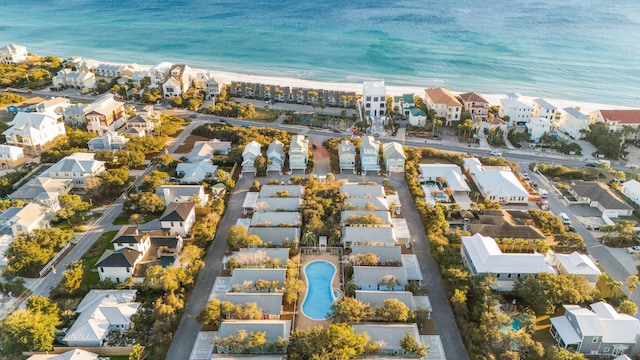 drone / aerial view with a water view, a view of the beach, and a residential view