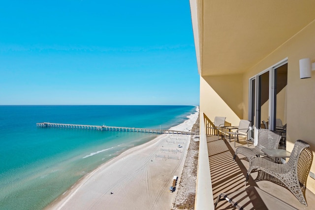 balcony with a view of the beach and a water view